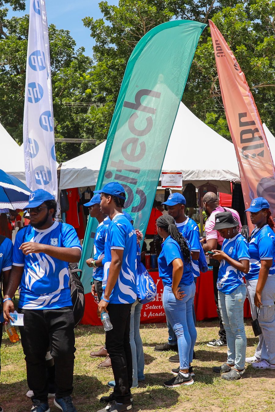 Students in blue shirts among the Expo Village banners